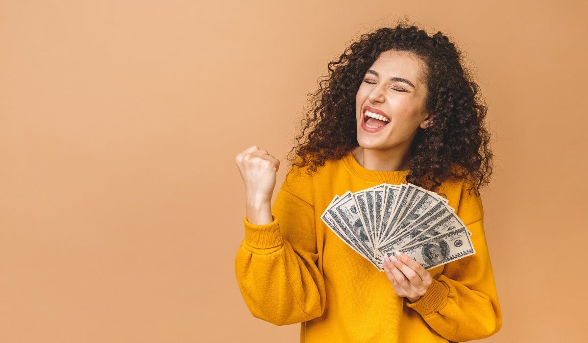 Happy bank customer smiling with money