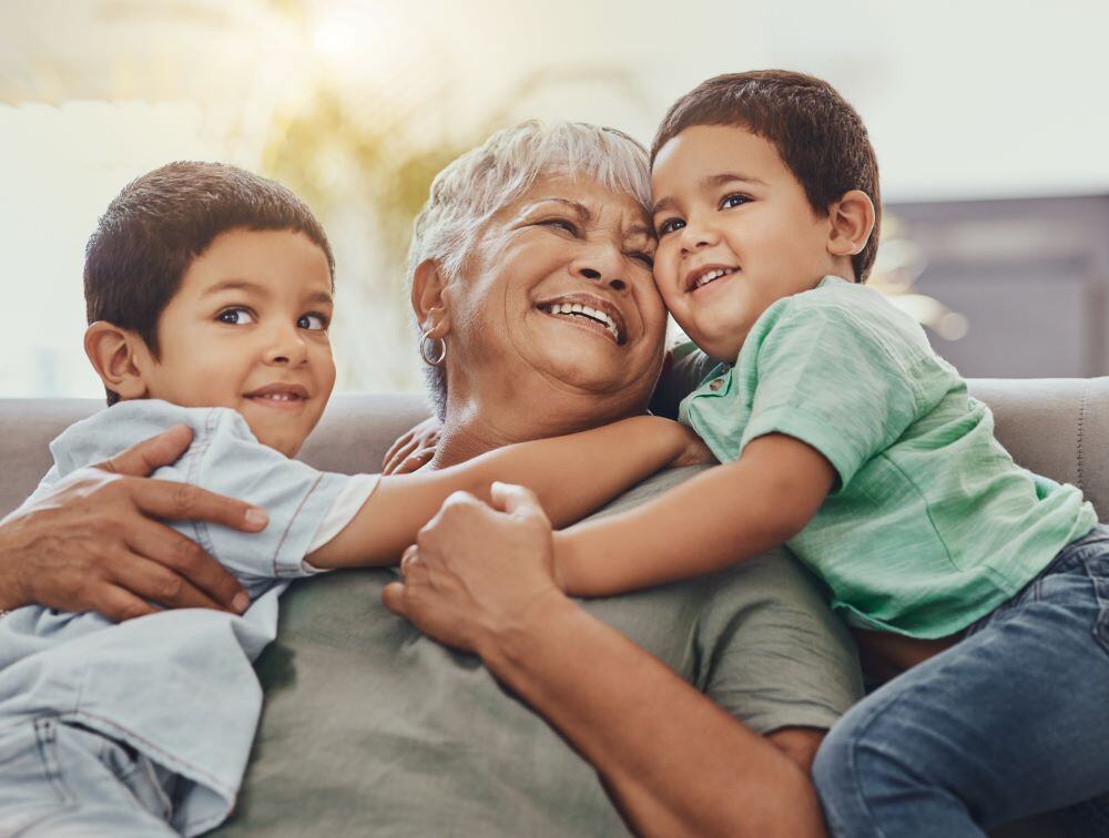 Picture of happy older hispanic woman spending time with her two young grandsons