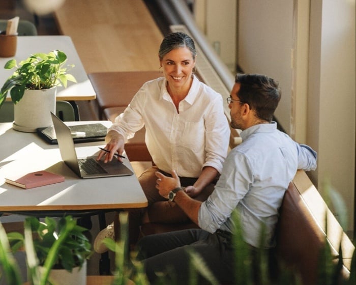 smiling-loan-agent-discussing-options-with-customer-1