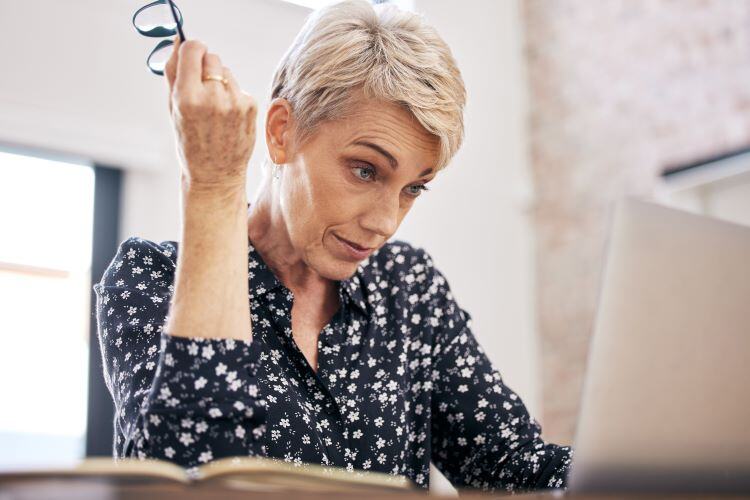 Frustrated retirement-aged woman struggling to figure out her estate plans