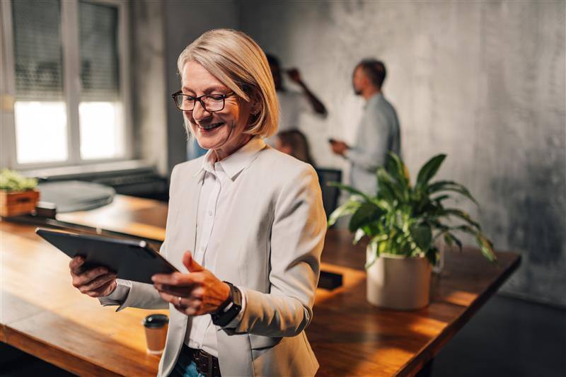 smiling-senior-businesswoman-looking-at-tablet-at-2024-04-30-17-56-00-utc